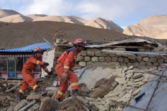 In this photo released by Xinhua News Agency, rescue workers conduct search and rescue for survivors in the aftermath of an earthquake in Changsuo Township of Dingri in Xigaze