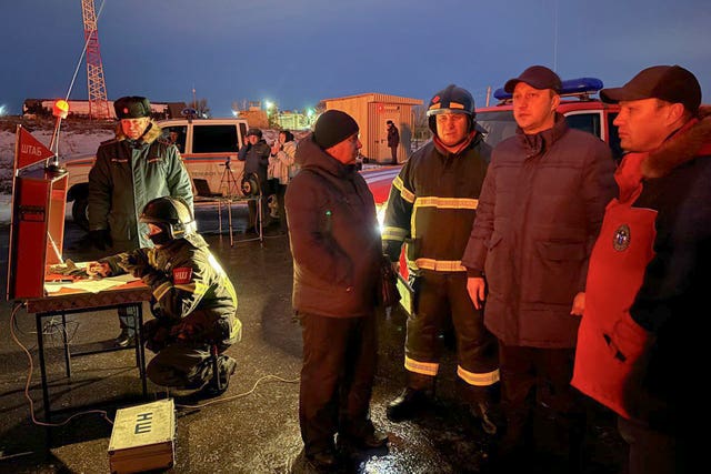 Governor of the Saratov region Roman Busargin, second right, speaks to firefighters