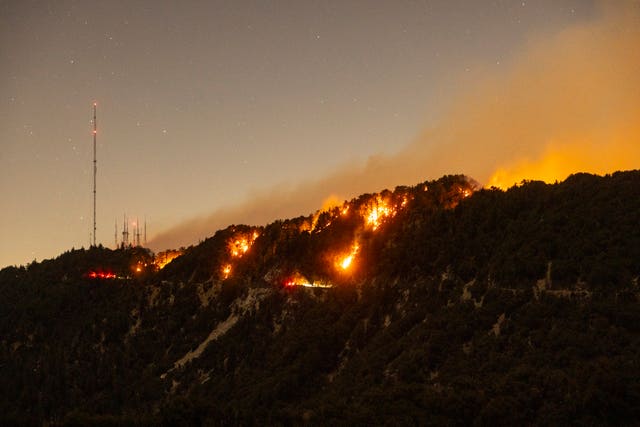 Spots of the Eaton Fire still burn after the fire swept through the mountains of the Angeles National Forest