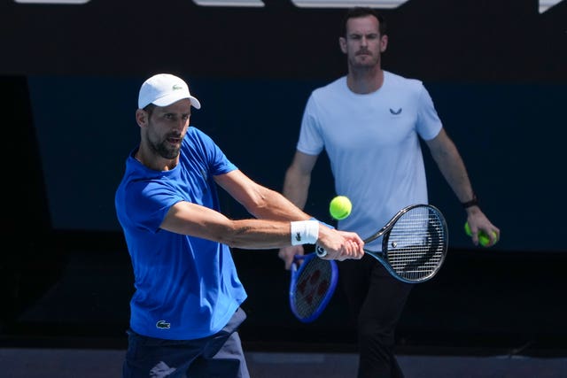 Andy Murray, right, watches Novak Djokovic practise