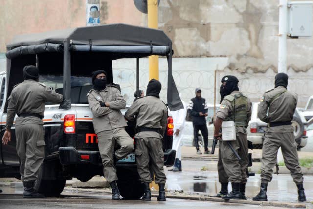 Mozambique’s special forces members deployed to guard opposition leader Venancio Mondlane as he addresses his supporters on the street in Maputo, Mozambique