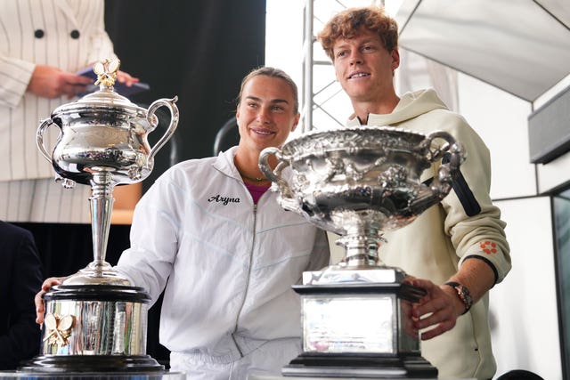 Defending champions Aryna Sabalenka and Jannik Sinner with the trophies 