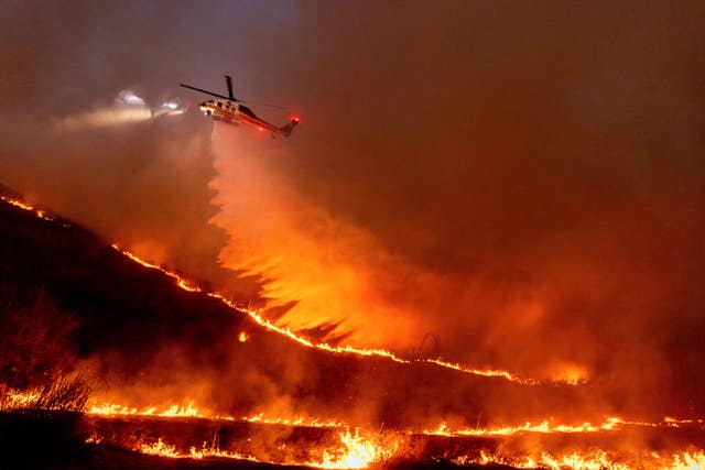 Water is dropped by helicopter on the Kenneth Fire in the West Hills section of Los Angeles 