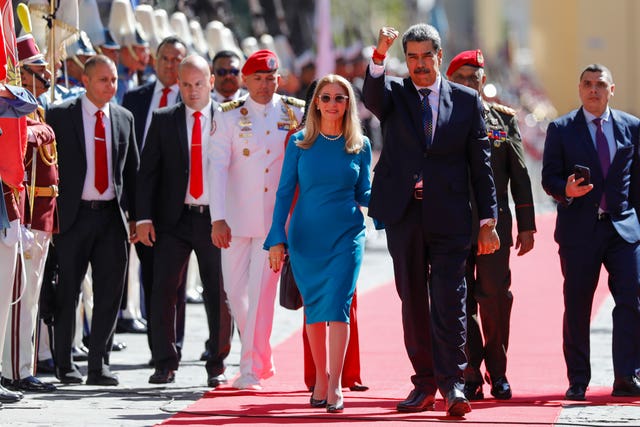 Venezuelan President Nicolas Maduro and his wife Cilia Flores arrive at the National Assembly for his swearing-in ceremony