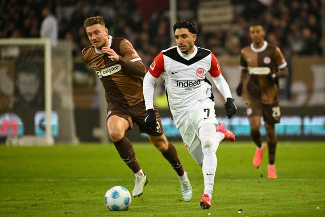 Eintracht Frankfurt’s Omar Marmoush challenges an opponent for the ball 