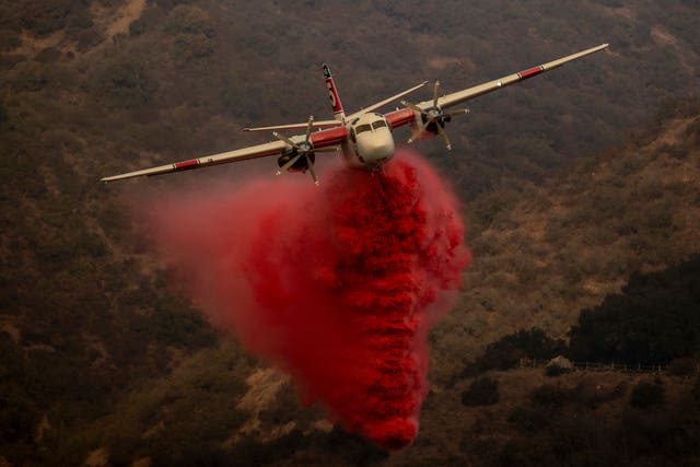 A firefighting aircraft releases retardant 