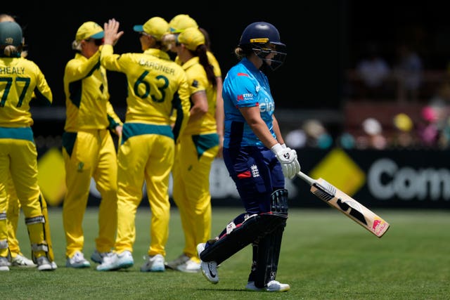 Australia's players celebrate as Alice Capsey trudges off