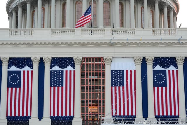 US flags hanging from the Capitol building