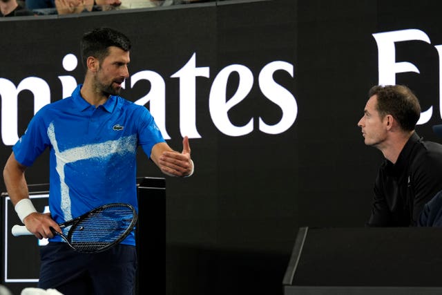 Novak Djokovic (left) of Serbia talks to his coach Andy Murray