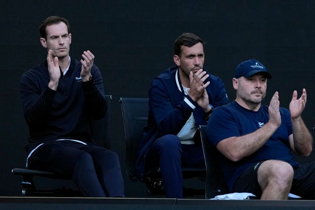 Andy Murray, left, claps in the courtside coaching pod