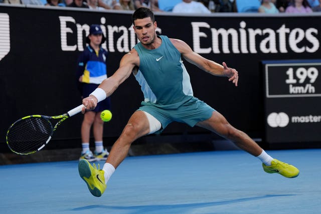 Carlos Alcaraz stretches for a forehand