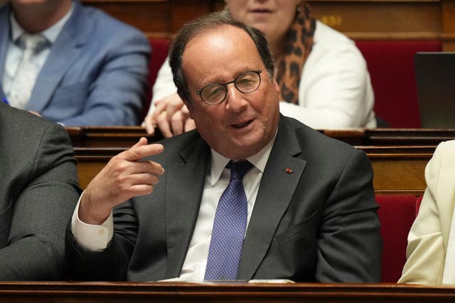 Former French president Francois Hollande gestures as he listens to French Prime Minister Francois Bayrou delivering his general policy speech at the National Assembly in Paris