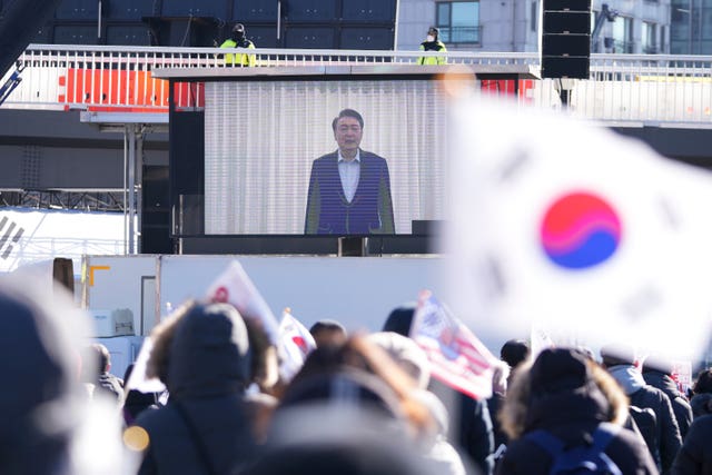 A screen displays footage of impeached South Korean President Yoon Suk Yeol as supporters stage a rally to oppose his impeachment near the presidential residence in Seoul