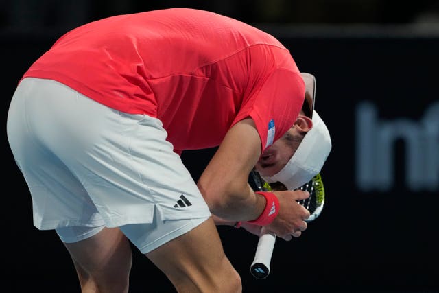 Jacob Fearnley crouches down and puts his head in his hands after winning