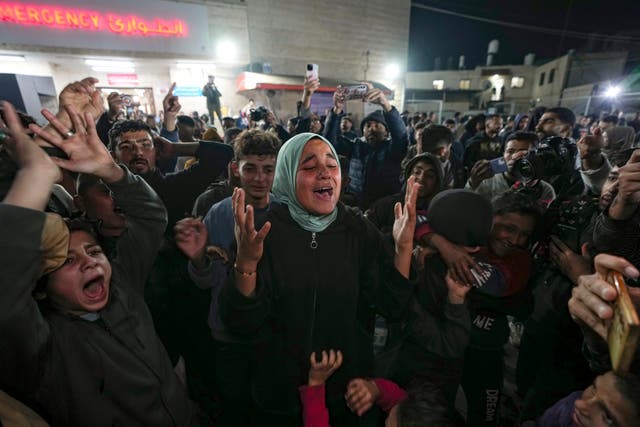 Palestinians celebrate the announcement of a ceasefire deal between Hamas and Israel in Deir al-Balah, central Gaza