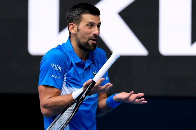 Novak Djokovic looks towards his coaching box