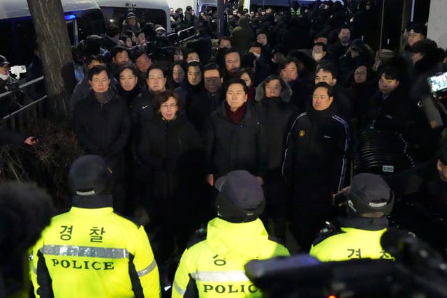 Politicians from the ruling People Power Party speak to media outside of the gate of the presidential residence in Seoul