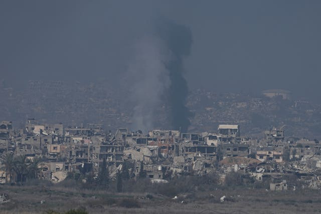 Smoke rising in Gaza behind buildings destroyed by Israeli bombardments