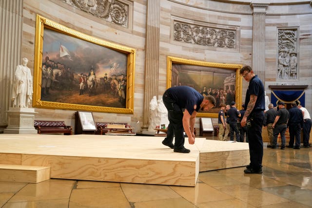 Workers building a stage in the US Capitol Rotunda