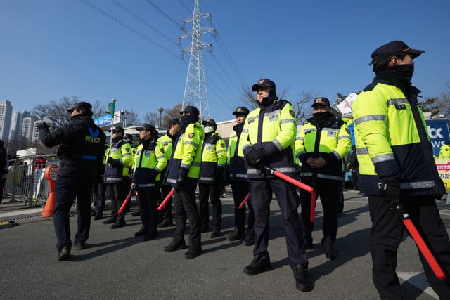 Police officers stand guard outside of the detention centre where President Yoon Suk Yeol is being held in Uiwang