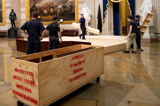 Workers building a stage in the US Capitol Rotunda