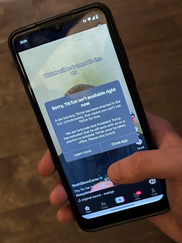 A message reading 'Sorry, TikTok isn’t available right now' is displayed from the TikTok app on a mobile phone screen 