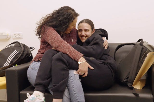 Romi Gonen, right, and her mother Merav hold each other near kibbutz Reim, southern Israel, after Romi was released from captivity by Hamas militants in Gaza