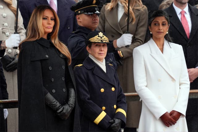 Melania Trump and Usha Vance arrive before President-elect Donald Trump participates in a wreath-laying ceremony at Arlington National Cemetery in Arlington, Virginia 