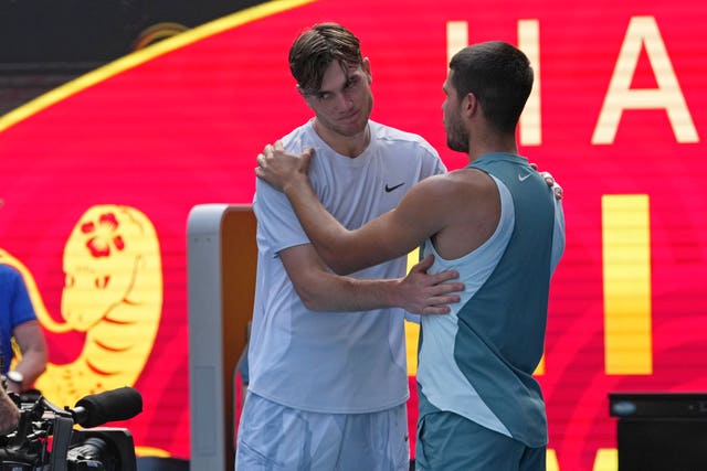 Jack Draper, left, is comforted by Carlos Alcaraz after coming off injured