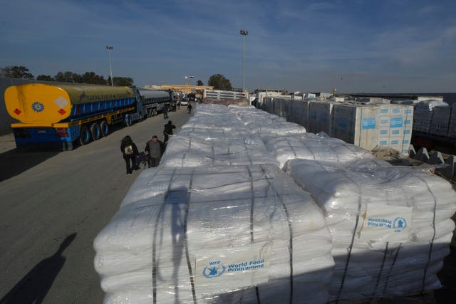 Trucks carrying humanitarian aid line up to cross the Rafah border crossing between Egypt and the Gaza Strip