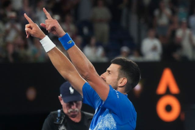 Novak Djokovic points to the crowd with both hands following his fourth-round win over Jiri Lehecka