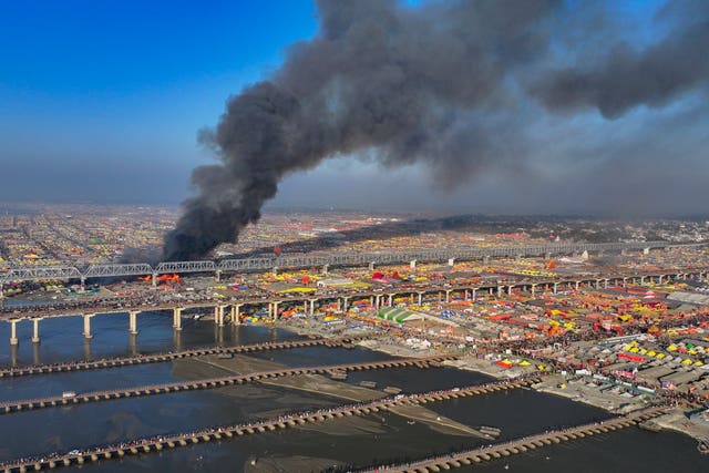 Smoke rising in the distance next to a river