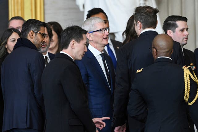 From left, Google CEO Sundar Pichai, TikTok CEO Shou Chew, Apple CEO Tim Cook and Tesla and SpaceX CEO Elon Musk speak with each other at the conclusion of the 60th Presidential Inauguration in the Rotunda of the US Capitol in Washington