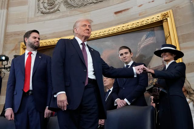 Donald and Melania Trump hold hands as they return to the White House