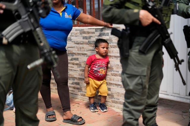 Police guard a school serving as a shelter 