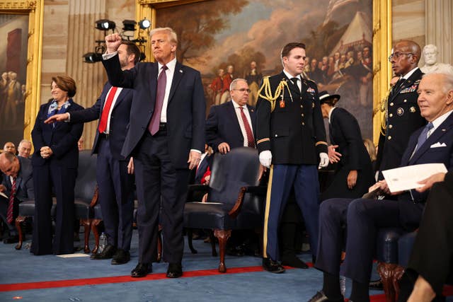 President Donald Trump gestures during the 60th Presidential Inauguration in the Rotunda of the US Capitol in Washington 