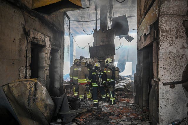 Firefighters inside the damaged building 