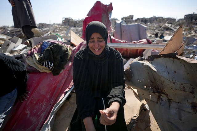 Manual Aslim reacts over the ruins of her destroyed home, in Rafah