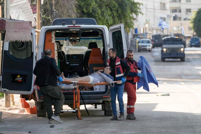 Medics evacuate a wounded man during an Israeli military operation in the West Bank city of Jenin