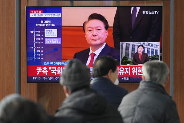 A TV screen shows footage of impeached South Korean President Yoon Suk Yeol at the Seoul Railway Station