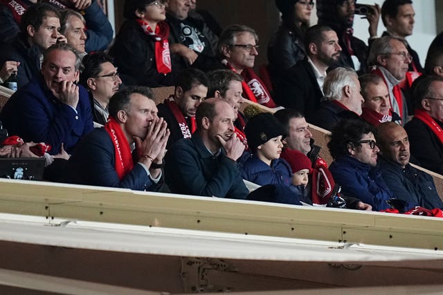 The Prince of Wales watches the action in the stand