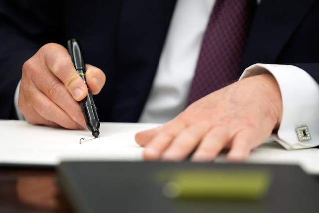 Close-up of Donald Trump's hands as he signs an executive order