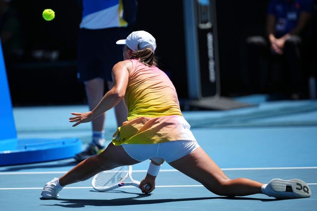 Iga Swiatek lunges for a ball 