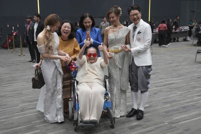 Rungtiwa Thangkanopast, fourth from right, and Phanlavee, right, whose photo was taken on condition of anonymity of the last name, pose for a group photo with other family members after the Marriage Equality Act took effect in Bangkok, Thailand 