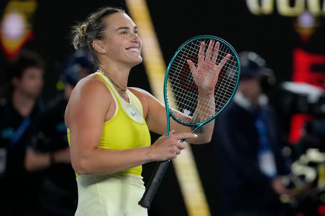 Aryna Sabalenka applauds the crowd with her racket