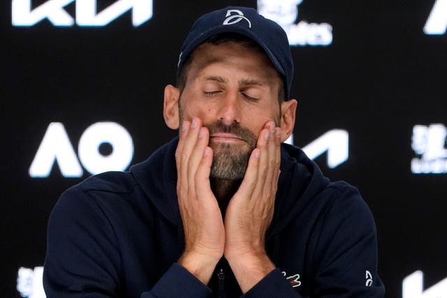 Novak Djokovic shuts his eyes with his hands on his face during a press conference