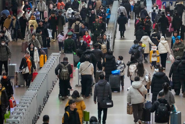 A woman directs rail travellers