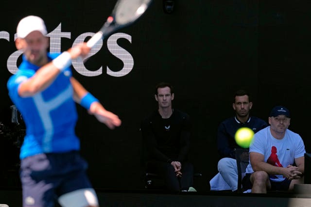 Andy Murray, second left, watches Novak Djokovic