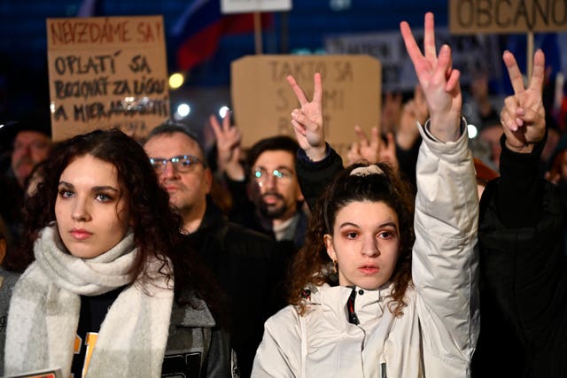 Protesters make the V sign 