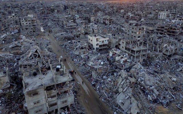 An aerial photograph taken by a drone shows Palestinians walking through the destruction caused by the Israeli air and ground offensive, in Rafah, Gaza Strip